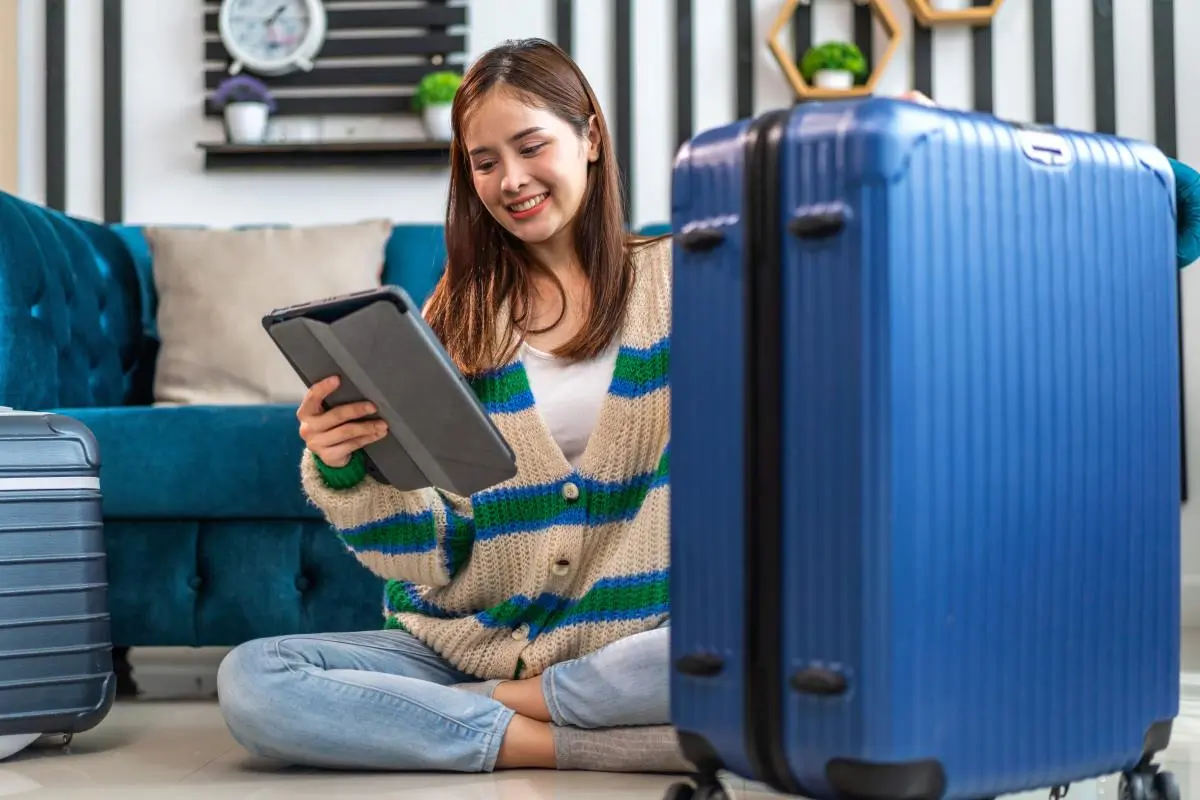 lady with suitcase using advanced payment technology to purchase holiday