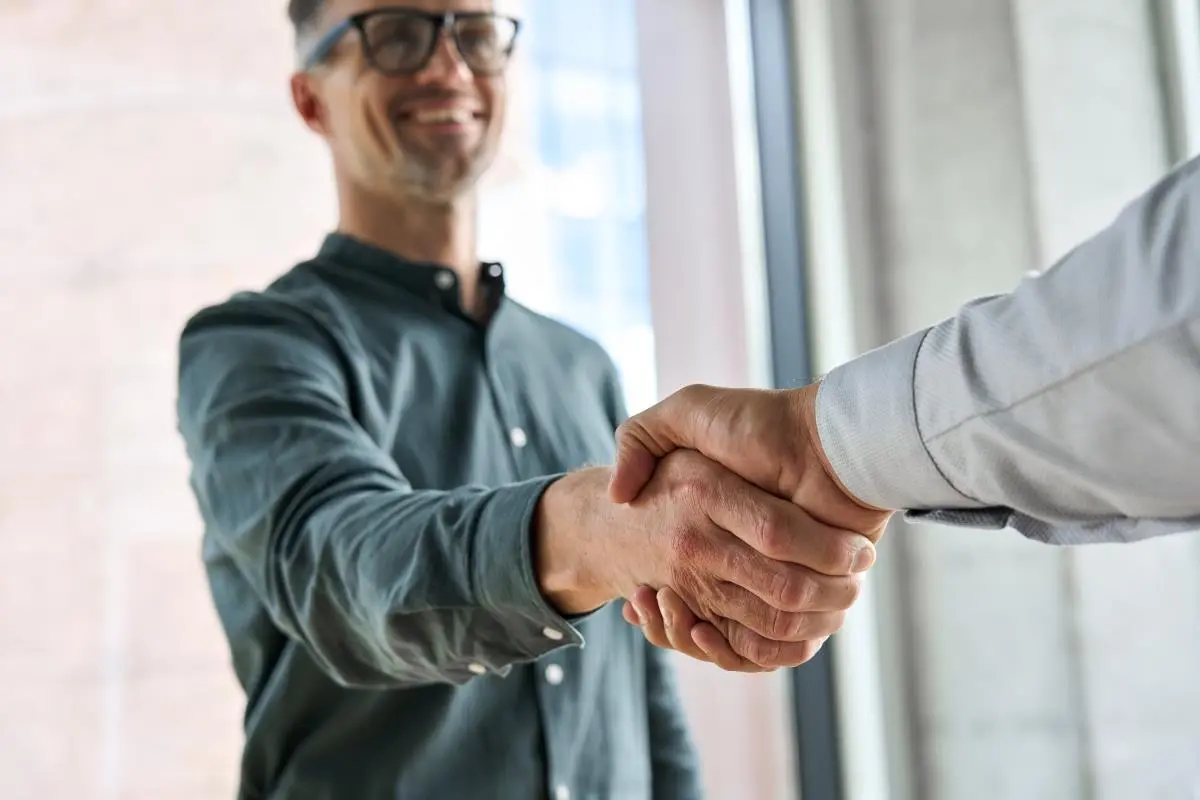 business owner shaking hands with customer building customer trust