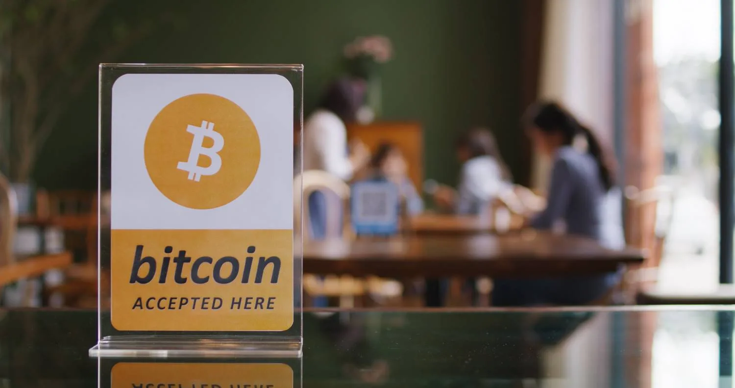 a sign at a store showing that bitcoin crypto payments are accepted